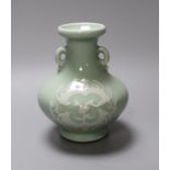 A Chinese celadon two handled vase with slip decoration, 15cm tall