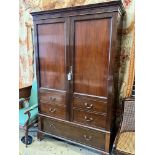 A 1920's mahogany press cupboard with part dummy drawer front over a single drawer, width 120cm,