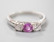 A modern platinum, pink sapphire and two stone round cut diamond set ring, size O, gross weight 5.