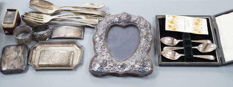 A mixed collection of silver to include cutlery, napkin rings, photograph frame, card cases, small