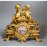 A French putti mounted spelter mantel clock, 32cm