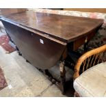 An early 18th century style oak oval topped gateleg dining table, (one leaf in need of repair),