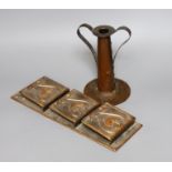 An Arts and Crafts hammered copper candlestick, 18cm tall, and a copper hanging letter rack