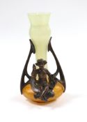A small Art Nouveau glass vase with bronze mount and seated cherub, 16cm tall