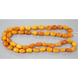A single strand oval amber bead necklace, 90cm, gross 81 grams, (two beads chipped).