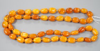 A single strand oval amber bead necklace, 90cm, gross 81 grams, (two beads chipped).
