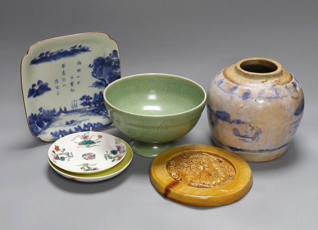 A celadon crackle glaze pedestal bowl, together with a blue and white inscribed dish, a 19th century