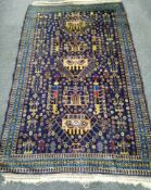 An Afghan blue ground rug, 180 x 112cm