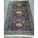 An Afghan blue ground rug, 180 x 112cm