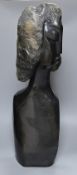 A Zimbabwean carved and polished stone head and upper torso of a woman, 61cms.