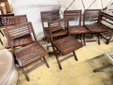 A set of six slatted teak garden chairs