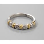 A modern platinum and yellow metal , four stone collet set diamond half hoop ring, size P, gross