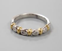 A modern platinum and yellow metal , four stone collet set diamond half hoop ring, size P, gross