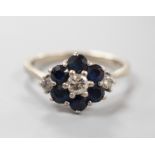 An 18ct white metal, sapphire and diamond set cluster ring, size O, gross weight 4.1 grams.