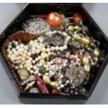 A quantity of assorted costume jewellery in a lacquer box.