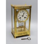 A late 19th century French four glass mantel clock, mercury pendulum and key, 26cm tall