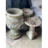 A reconstituted stone garden urn, height 63cm together with two stone bird baths