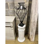 A painted wrought iron vase shaped ornament on painted fluted pedestal, total height 139cm