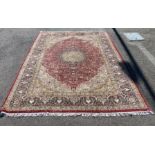 A Kashmiri part silk burgundy ground floral carpet, 330 x 240cm