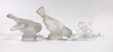 Two Lalique glass paperweights modelled as pecking birds, together with another Lalique swan