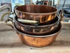 Three Victorian circular copper two handled preserve pans, largest diameter 43cm