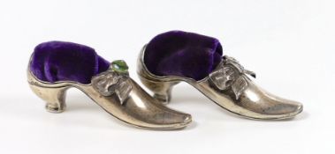 Two similar late Victorian novelty silver mounted pin cushions, modelled as shoes, one set with