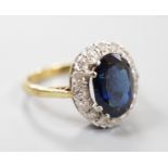 A modern 18ct gold, sapphire and diamond set oval cluster ring, size M, gross weight 4.9 grams.