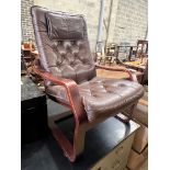 A 1970's Danish style buttoned brown leather and beech bentwood chair, width 69cm, depth 80cm,