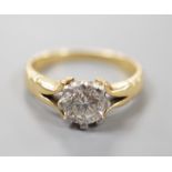 An 18ct and plat set solitaire diamond ring, size F, gross weight 2.9 grams, the stone weighing