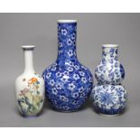 A Chinese blue and white bottle vase, a similar double gourd vase and a famille rose bottle vase a.