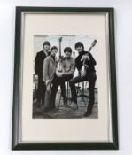 A Beatles signed photo in glazed frame, 23 x 17cm, bearing the signature of all four members with