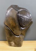 A Zimbabwean carved and polished stone abstract study of a crouching figure, 55cms.