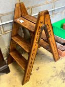 A pair of vintage style walnut folding cellar steps painted with champagne brands