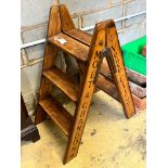 A pair of vintage style walnut folding cellar steps painted with champagne brands