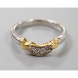 A modern platinum and yellow metal, four stone diamond set demi-lune ring, size N/O, gross weight