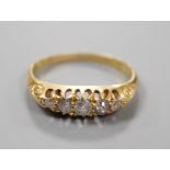 An Edwardian 18ct gold and graduated five stone diamond set half hoop ring, size M, gross weight 2.5