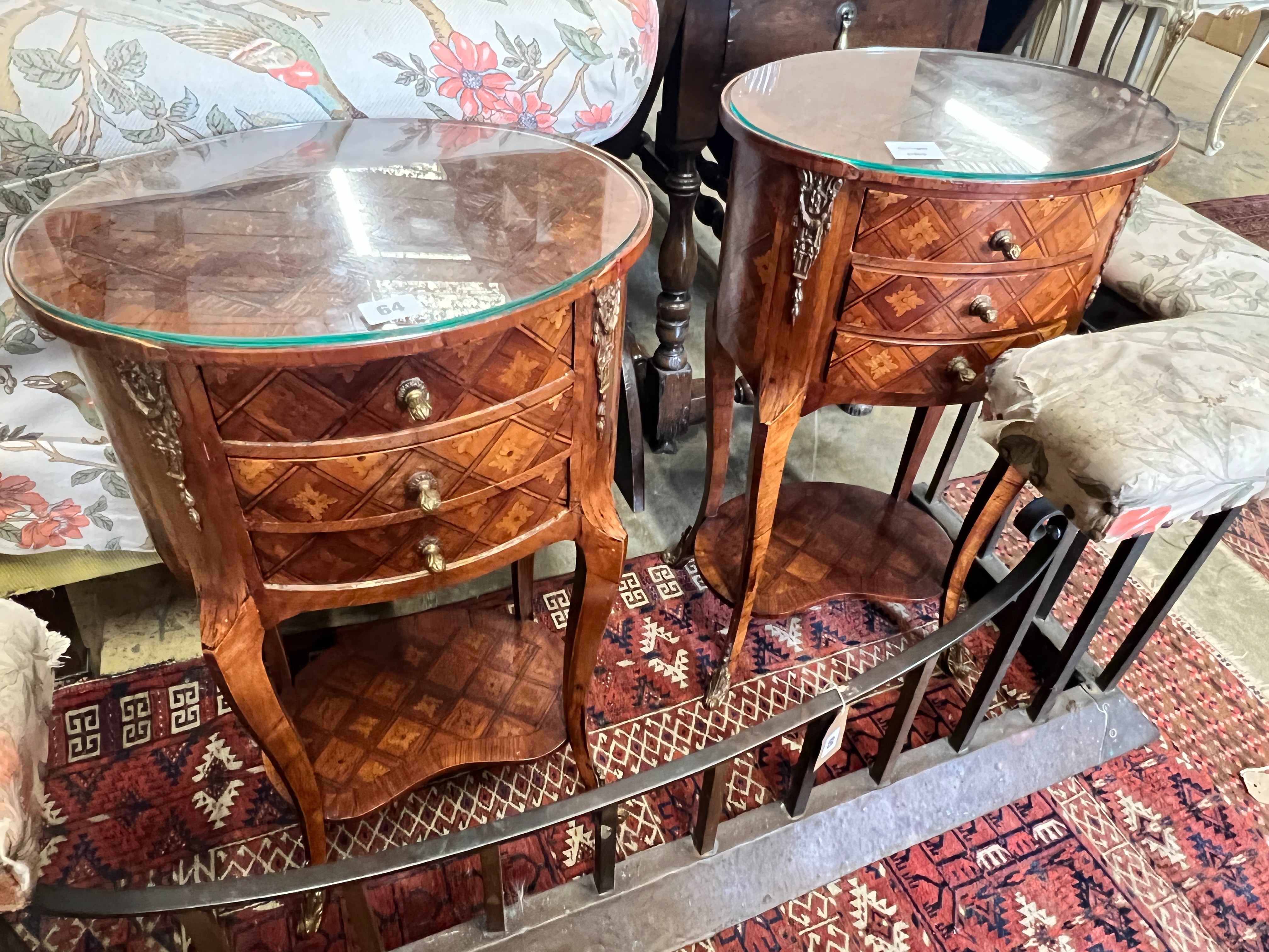 A pair of French transitional style oval parquetry inlaid bedside cupboards, kidney shaped under