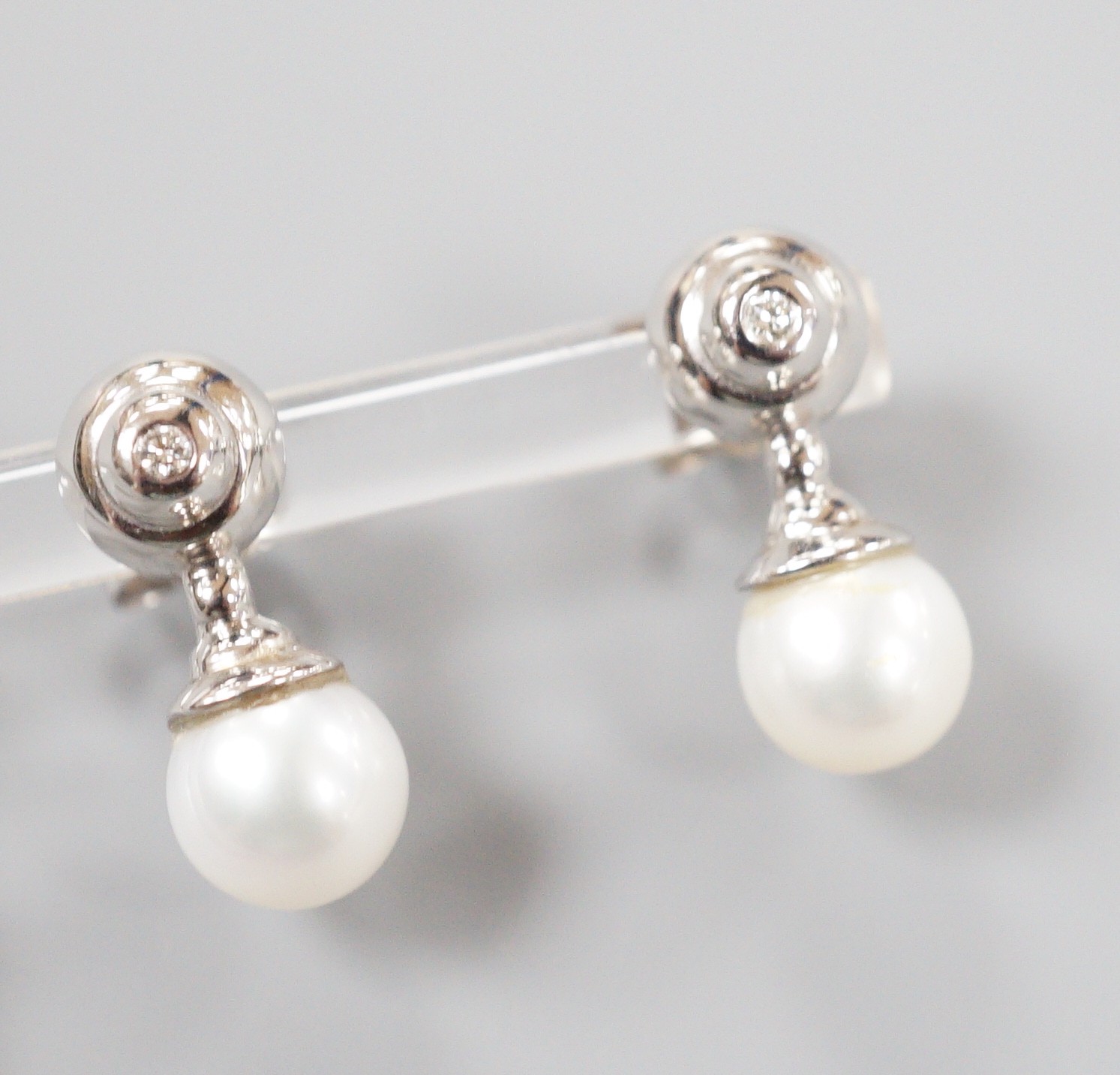 A modern pair of 198ct white gold cultured pearl and single stone collet set diamond ear studs, - Image 3 of 4