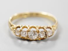 A late Victorian 18ct gold and graduated claw set five stone diamond half hoop ring, size N, gross