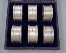 A cased set of six Victorian engraved silver napkin rings, Atkin Brothers, Sheffield, 1876.