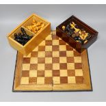Two complete wood carved cased chess set pieces, king: 8cm and 7.5cm tall, together with a playing