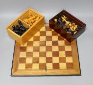 Two complete wood carved cased chess set pieces, king: 8cm and 7.5cm tall, together with a playing