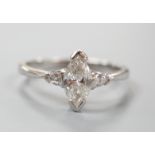 A modern platinum and single stone marquise diamond set ring, with two stone pear cut diamond set