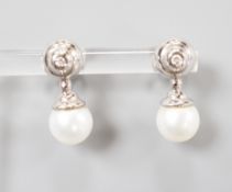A modern pair of 198ct white gold cultured pearl and single stone collet set diamond ear studs,