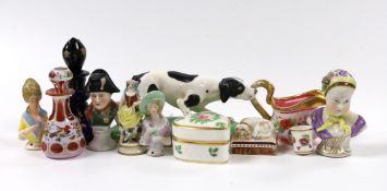 An early 19th century earthenware sleeping dog, a Victorian bone china model of a dog, a miniature