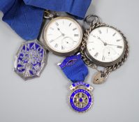 A small collection of silver badges and medals together with two silver pocket watches and a