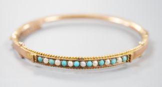 A late Victorian 9ct gold, seed pearl and turquoise set hinged bangle, 58mm, gross weight 6.7