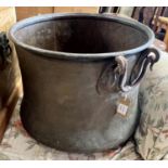 A Victorian circular copper cauldron with wrought iron handles, diameter 56cm, height 42cm