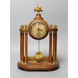 A small French portico clock with column decoration, 29cm tall