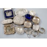 A collection of small silver items including napkin rings, repousse oval boxes, pair of bun salts,